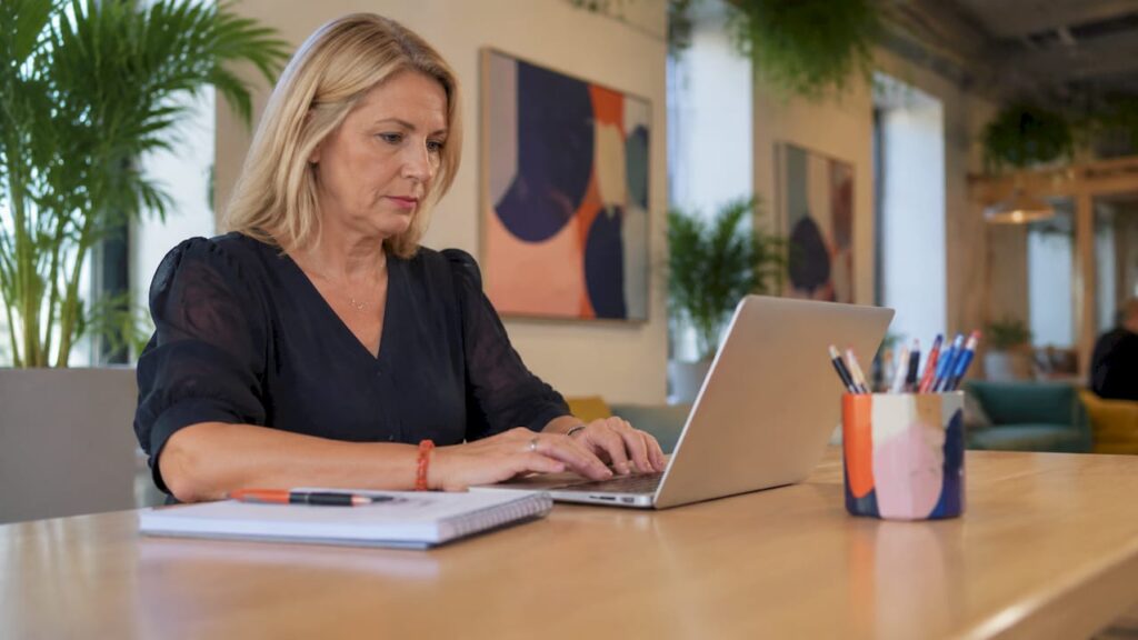 HR manager preparing recruitment ads at desk