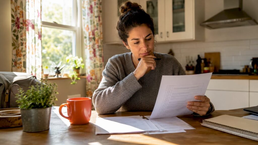 Small business owner reviewing hiring checklist