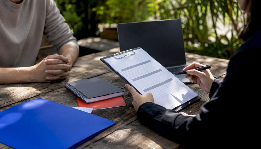 Hands holding structured hiring scorecard with work sample