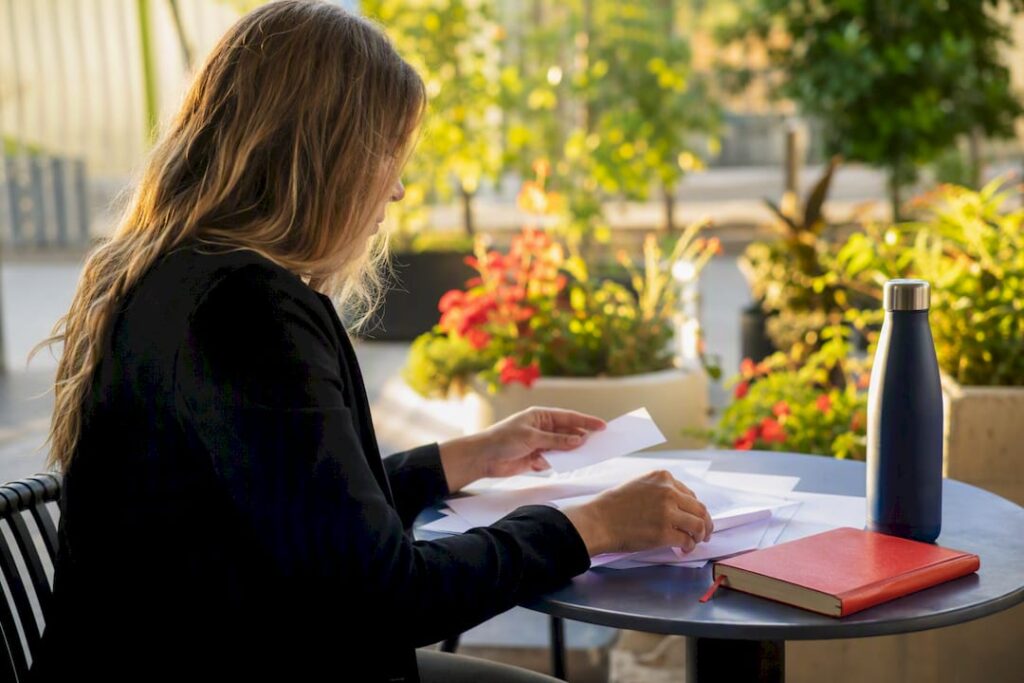 Hands adjusting job ad budget charts on desk